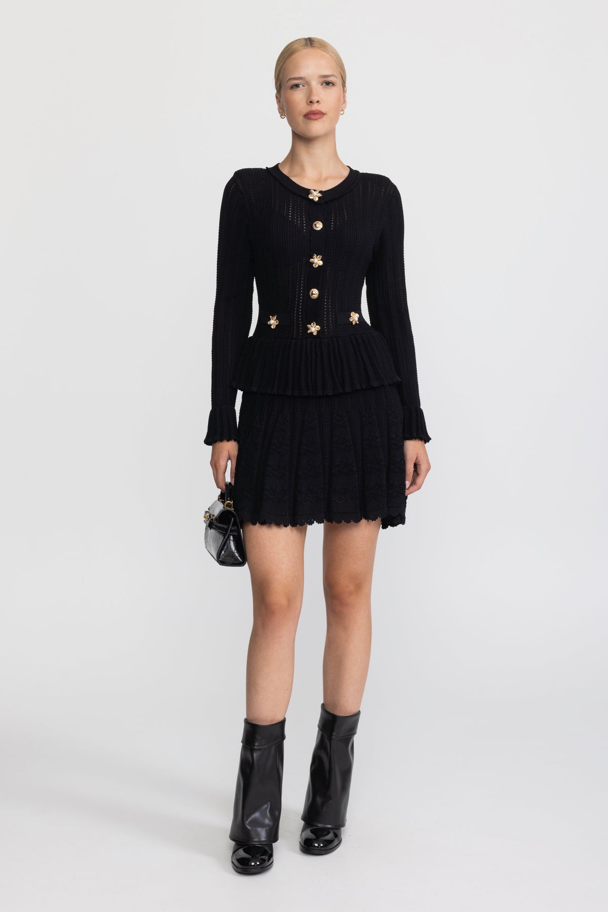 Abito mini peplum in maglia pointelle con bottoni a fiore - Nero