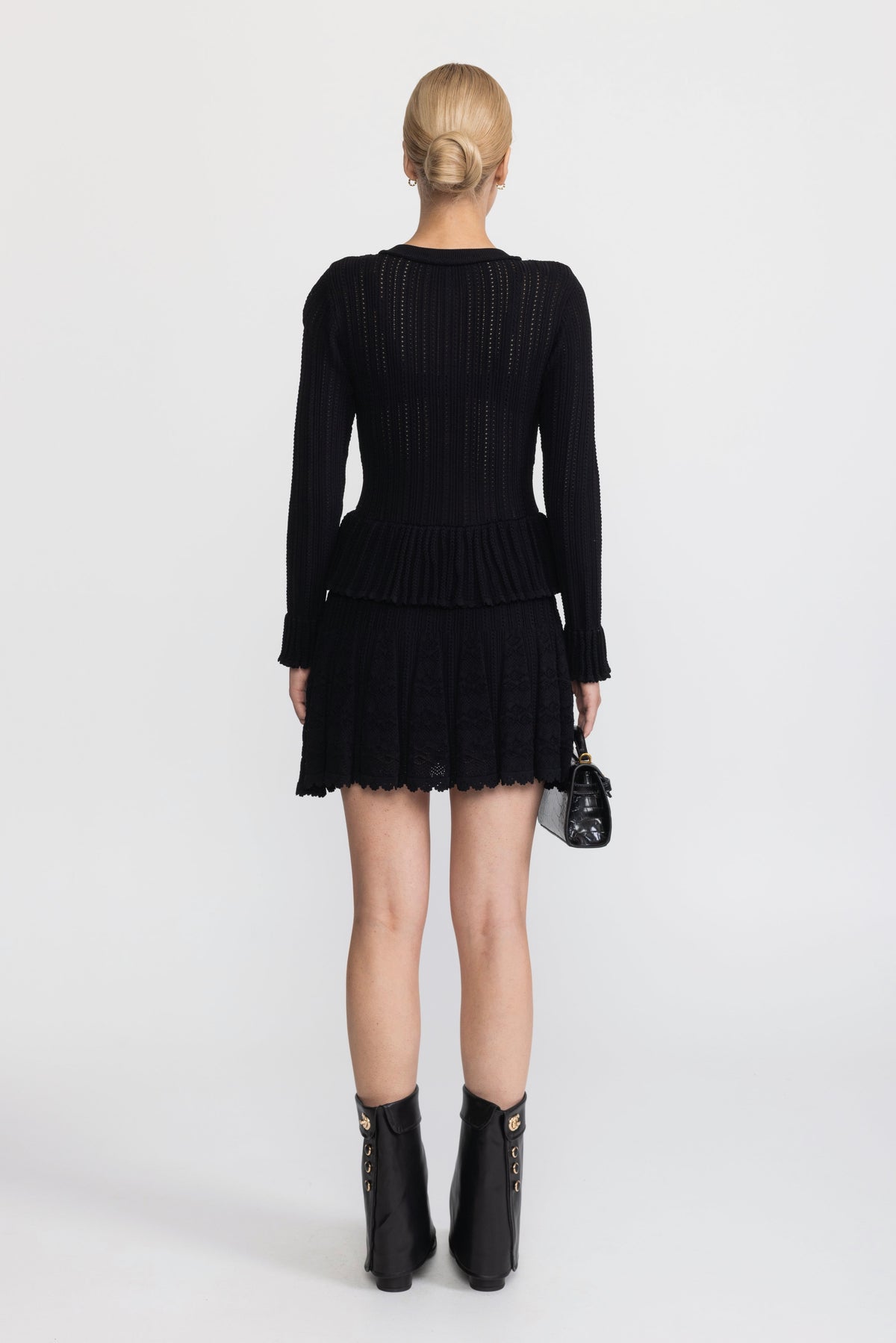 Abito mini peplum in maglia pointelle con bottoni a fiore - Nero