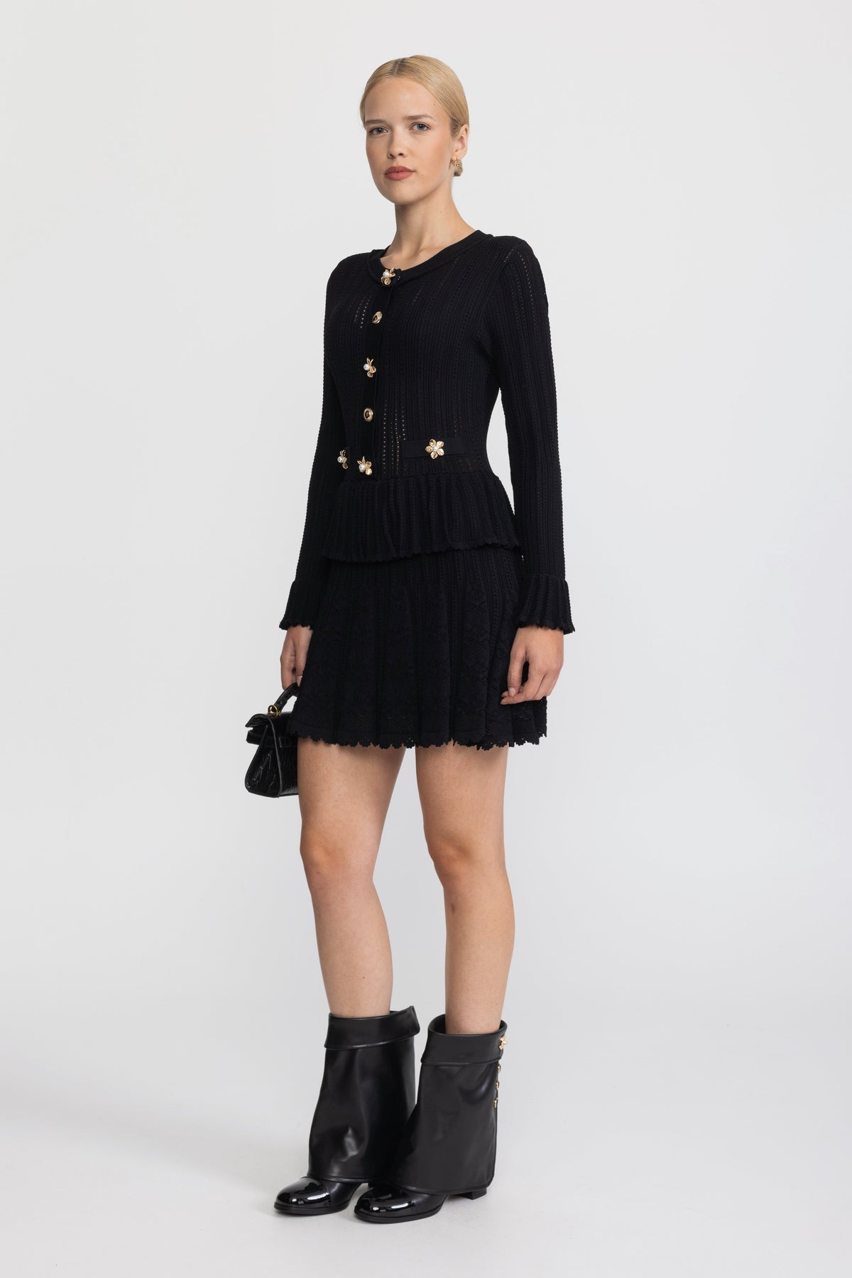 Abito mini peplum in maglia pointelle con bottoni a fiore - Nero