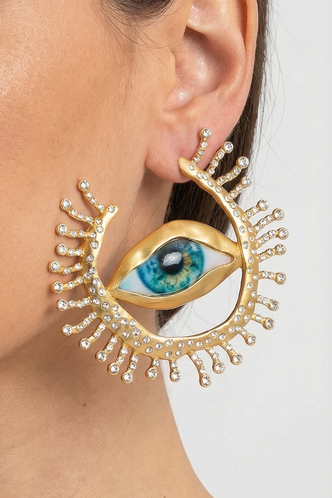 Statement Eye Stud Earrings with Crystal Ray Details – Gold