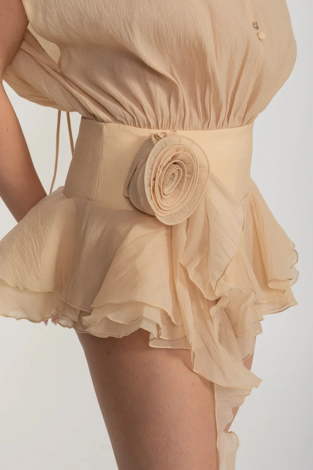 Elegant Mini Dress With Peplum Hem And Rosette Waist Embellishment - Beige